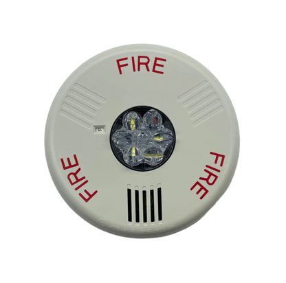 Eaton Wheelock ELHSWC fire alarm horn strobe with yellow casing, mounted on wall for fire safety and alert signaling.
