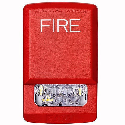 Eaton Wheelock ELSTR fire alarm strobe light with LED illumination, mounted on a ceiling in a safety setting