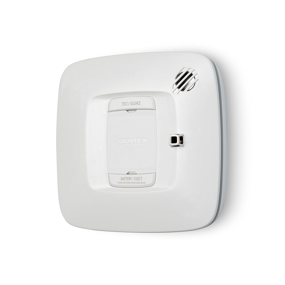 Gentex SC smoke and carbon monoxide detector mounted on ceiling, black rectangular alarm with digital display and test button