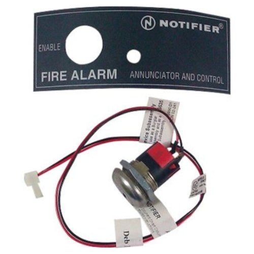 Black Notifier AKS-1B fire alarm annunciator key switch with label, designed for emergency signaling and control.